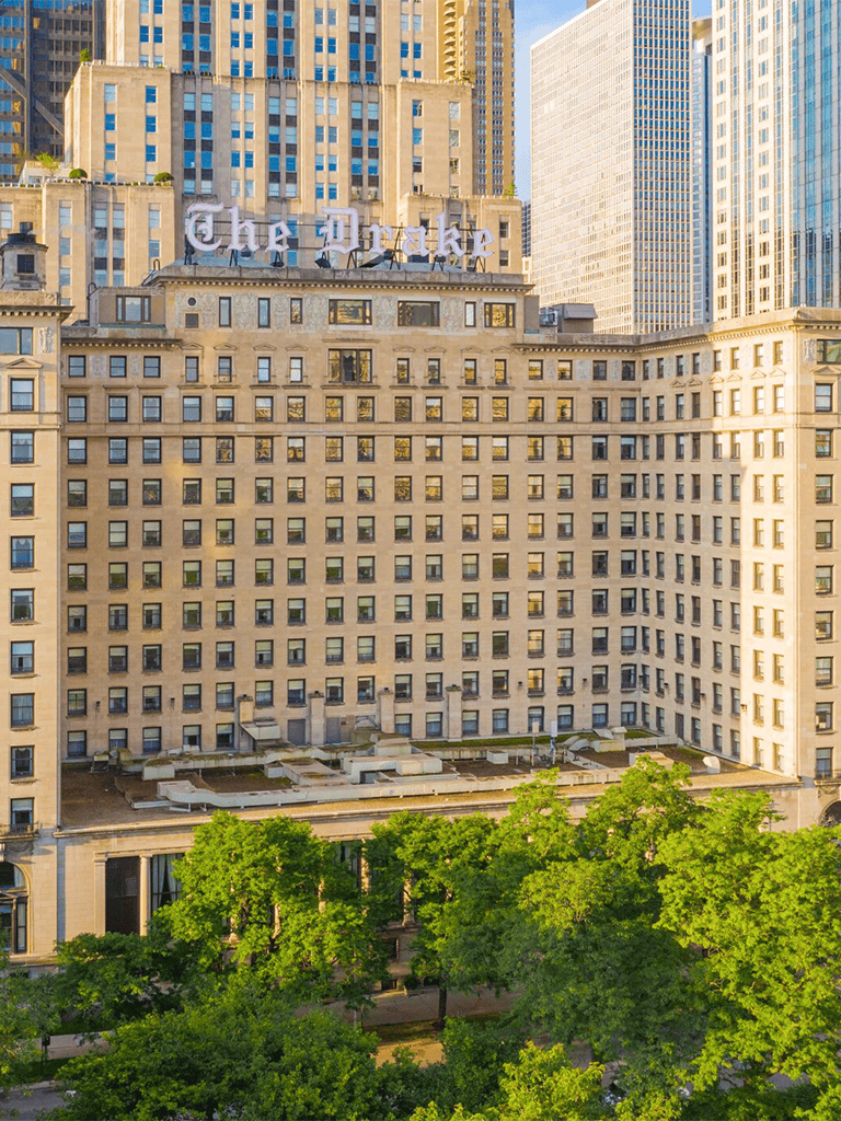 Historic downtown Chicago building with modern skyscrapers in background.