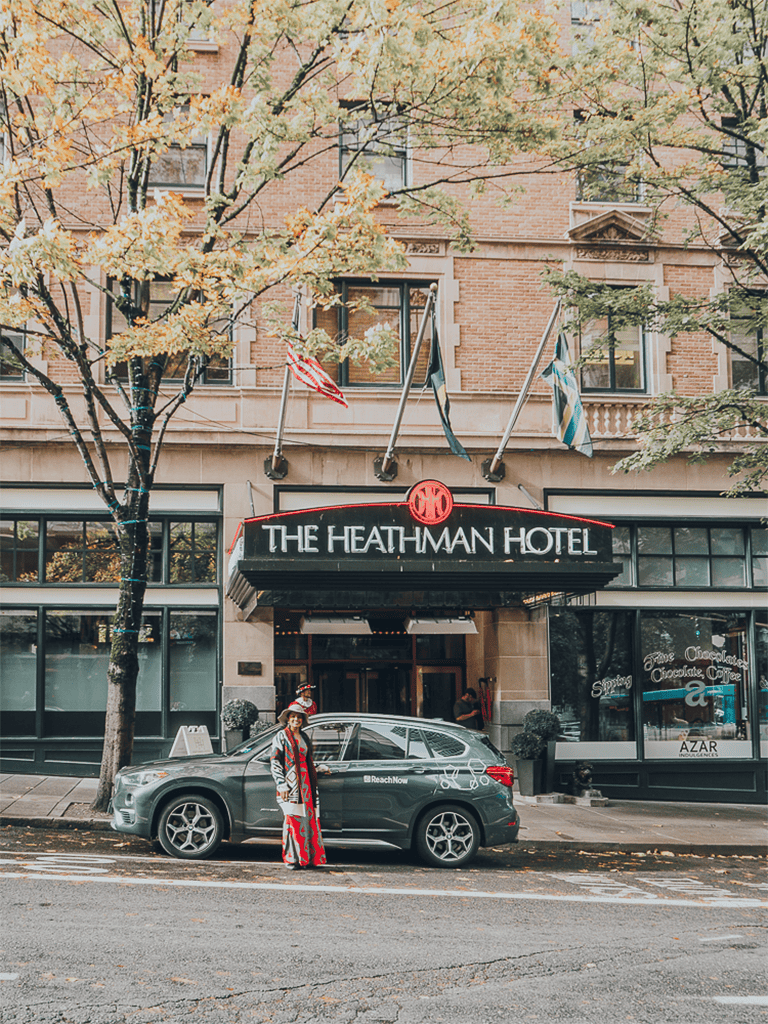 - Historic hotel entrance in downtown with flags and autumn trees.
