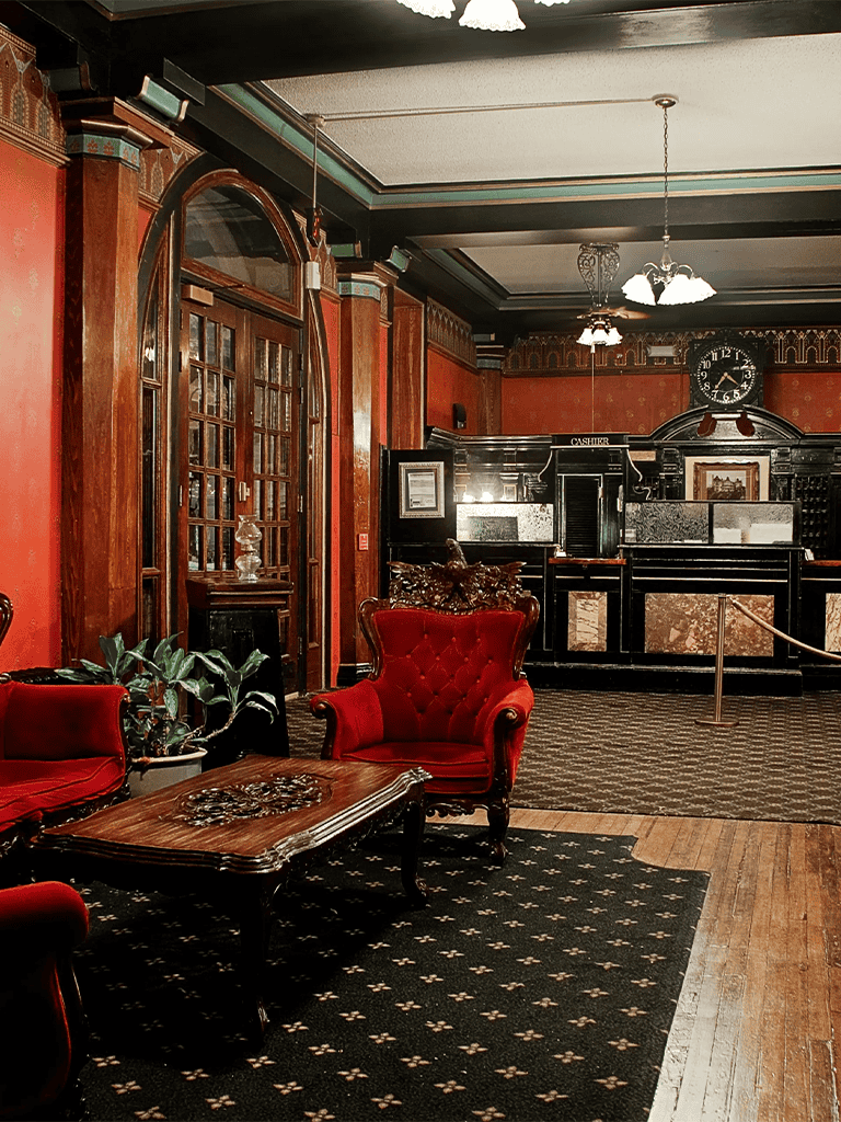 Elegant vintage hotel lobby with Victorian furniture and warm lighting.