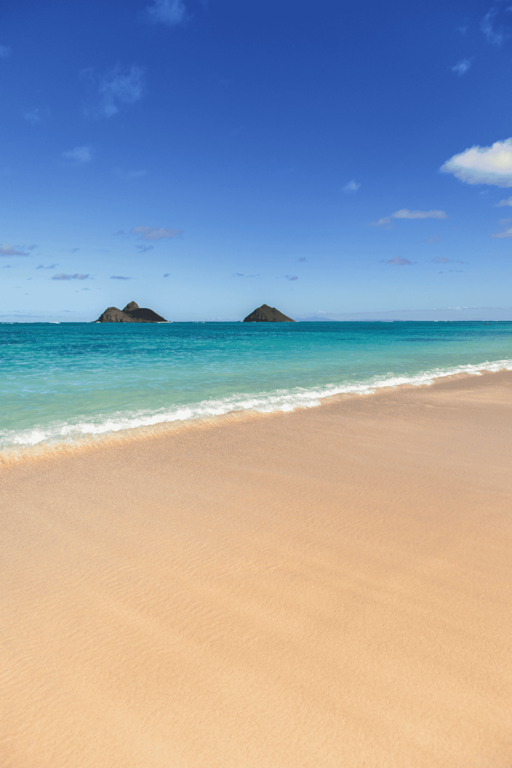 Secluded beach with turquoise waters and distant islands, perfect for relaxation and travel inspiration.