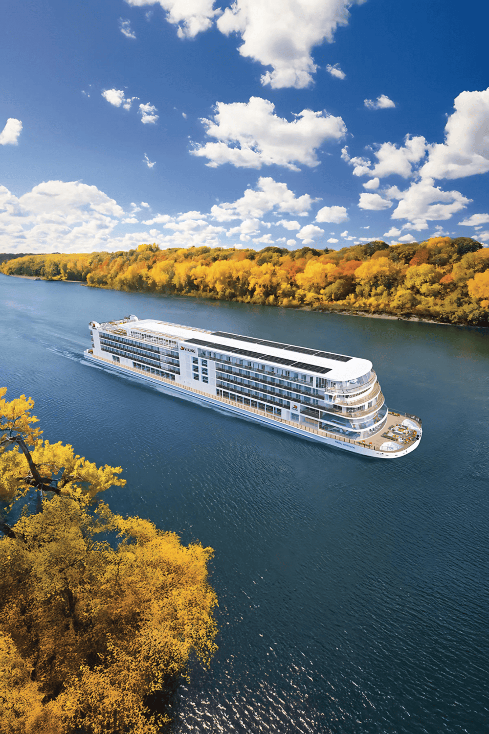 Elegant cruise ship sailing through autumn foliage along scenic river, perfect for travel and adventure.