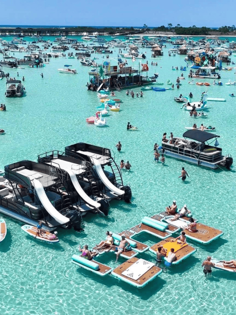 Colorful water activities and boats at QuestForDirections water park in a turquoise lagoon, perfect for family fun.