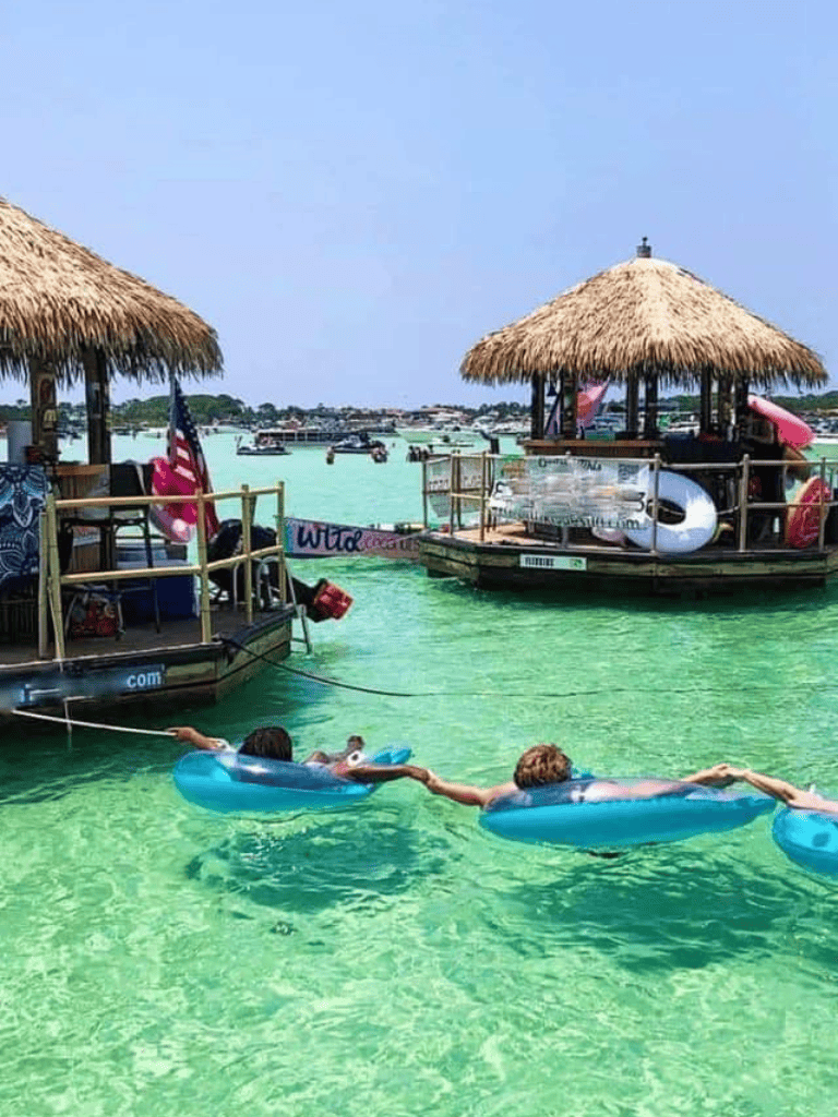 Colorful boat rentals at tropical beach destination, kids enjoying water fun, clear turquoise water, sunny day.