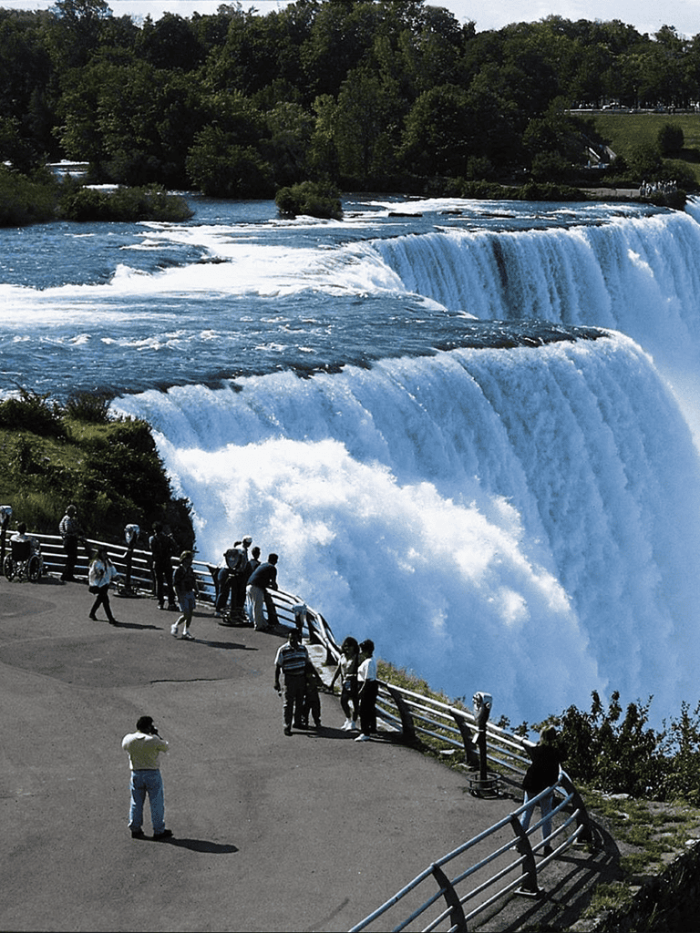Spectacular view of Niagara Falls from observation point attracting tourists and visitors.