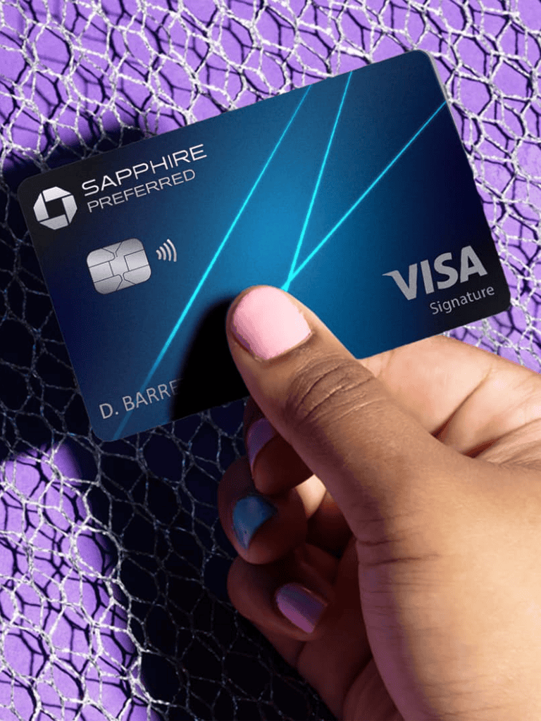Blue Sapphire Preferred Visa credit card held by a person with painted nails.