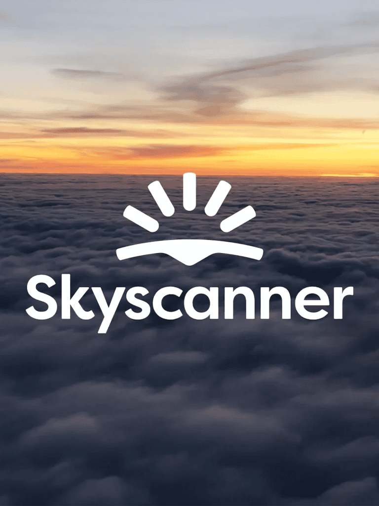 Aerial view of cloudy sky during sunset with Skyscanner logo.