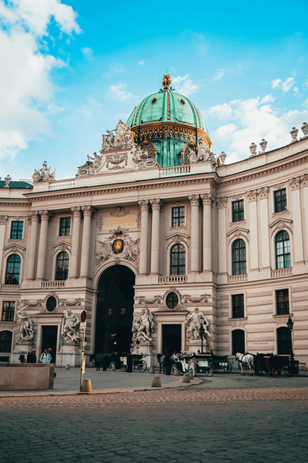 Ornate baroque palace with green dome and classical sculptures, Vienna Austria, travel destination, historic architecture.