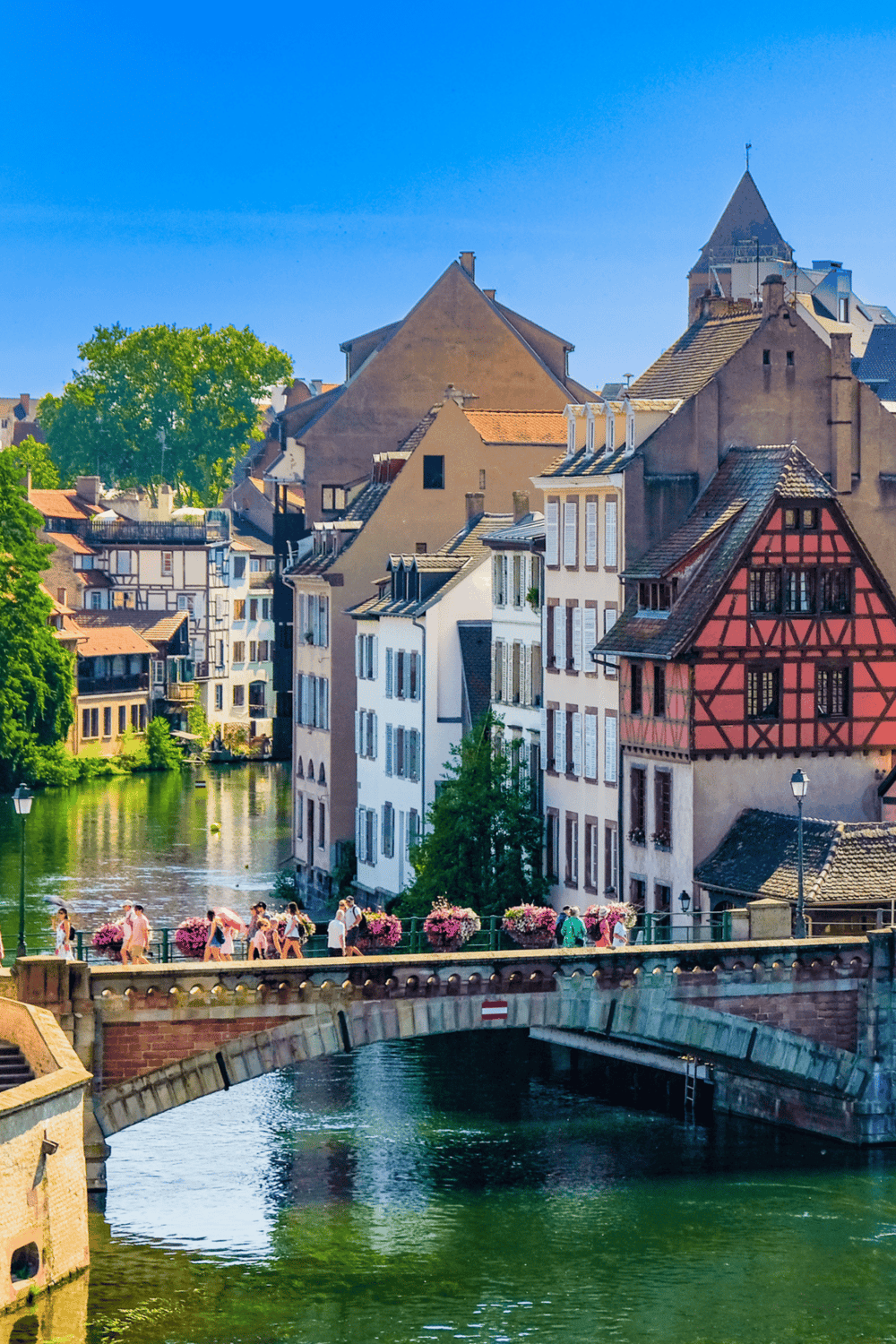 Charming European town with colorful buildings and a scenic river, perfect for travel planning and exploration.