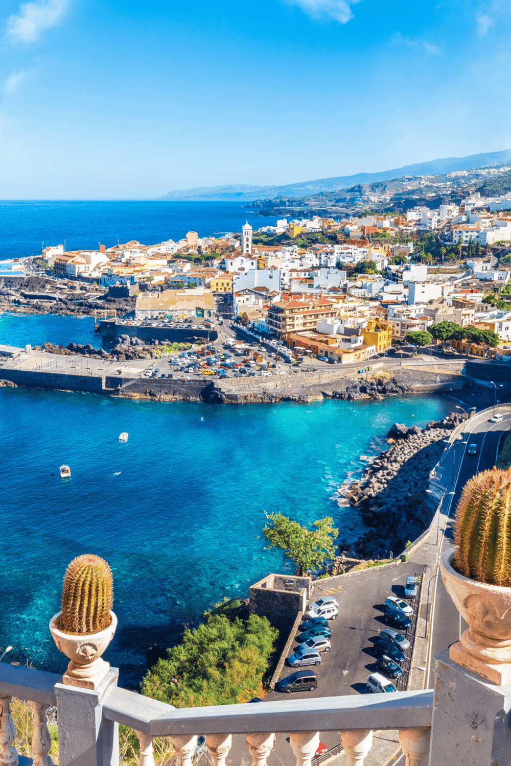 Colorful coastal cityscape in Lanzarote, Canary Islands, featuring vibrant buildings and turquoise ocean waters.
