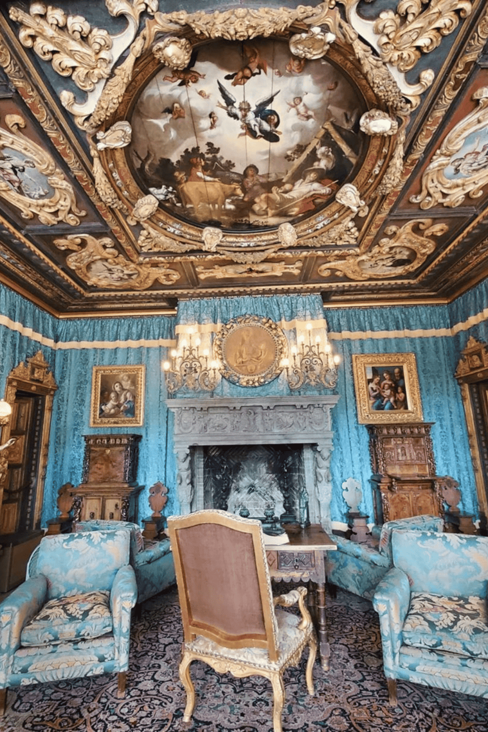 Ornate Baroque living room with colorful furniture and intricate ceiling artwork, luxurious interior decor.