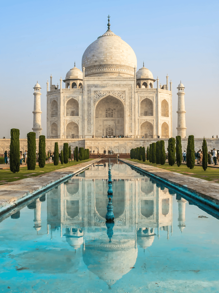 Majestic Taj Mahal in India with iconic white marble architecture and reflecting pool, a popular travel destination.