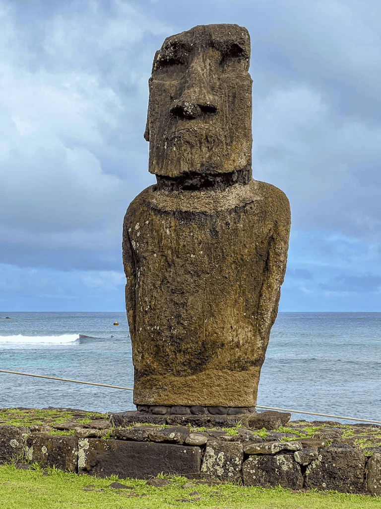 Ancient Moai statue on Easter Island overlooking the ocean, iconic cultural landmark for travel and exploration.