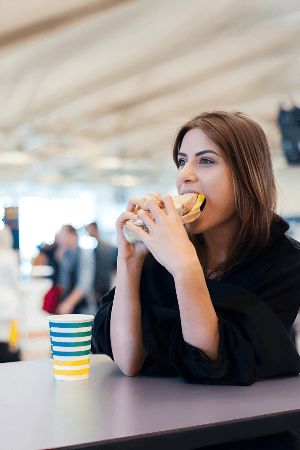Delicious sandwich and coffee at airport lounge, enjoying travel comfort and relaxation.
