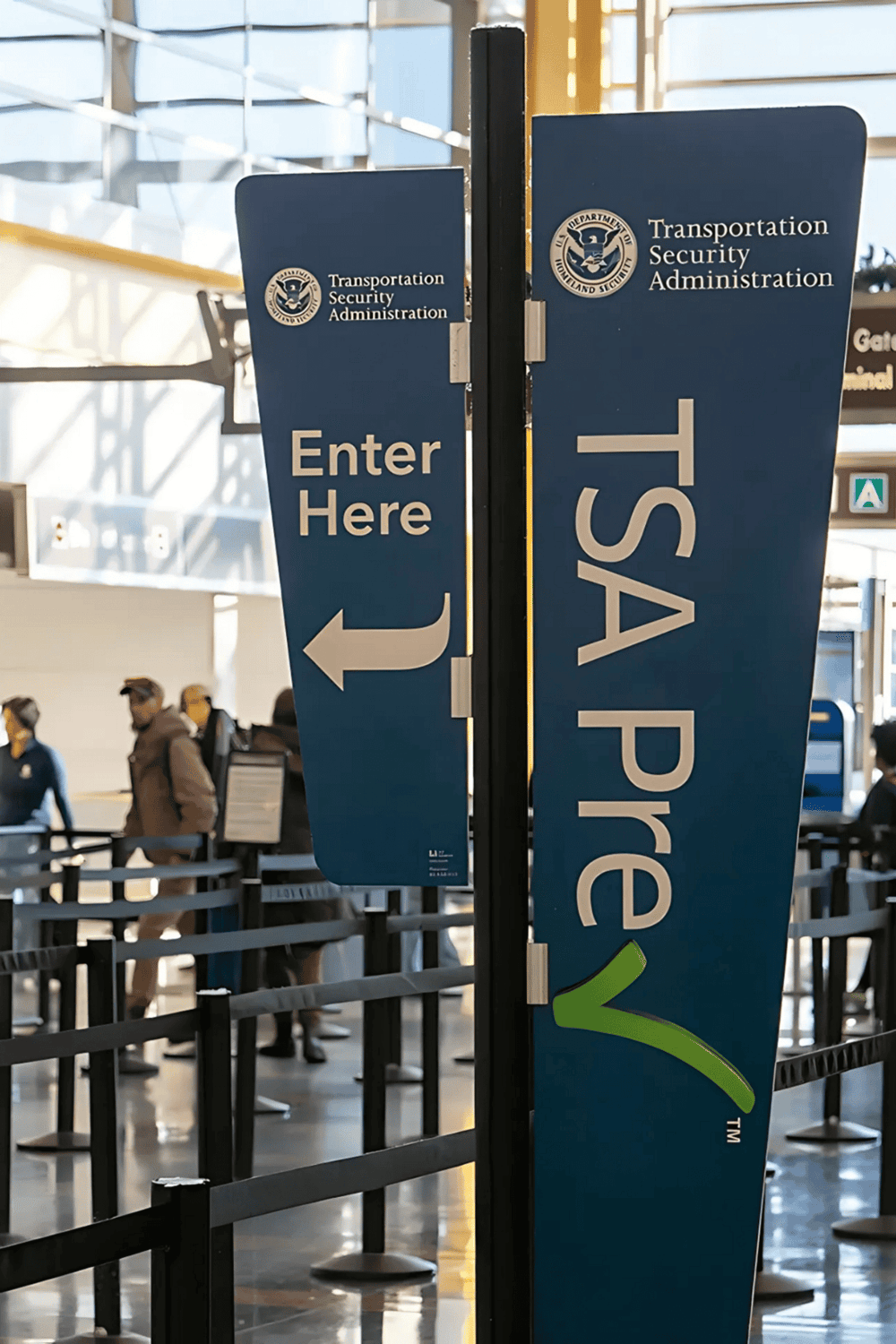 1. TSA precheck sign at airport security checkpoint, priority screening, expedited security process.