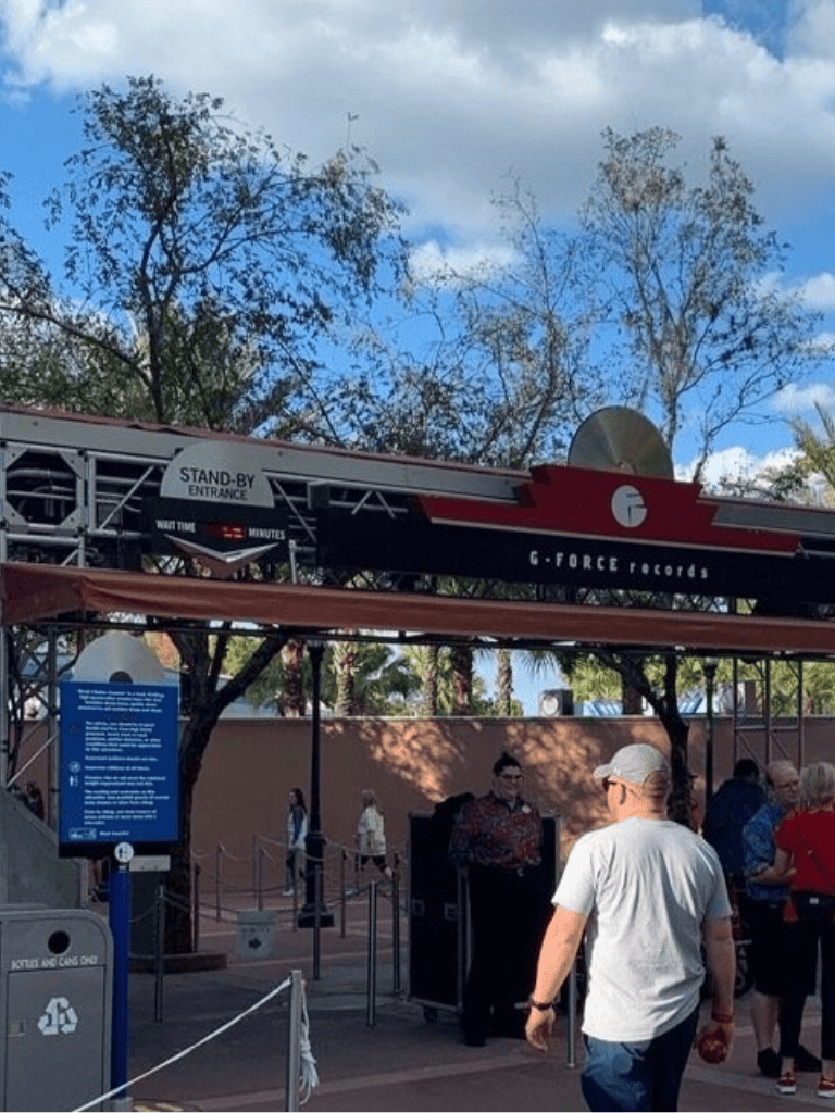 G-Force Records stand-by entrance at QuestForDirections amusement park, with visitors waiting in line.