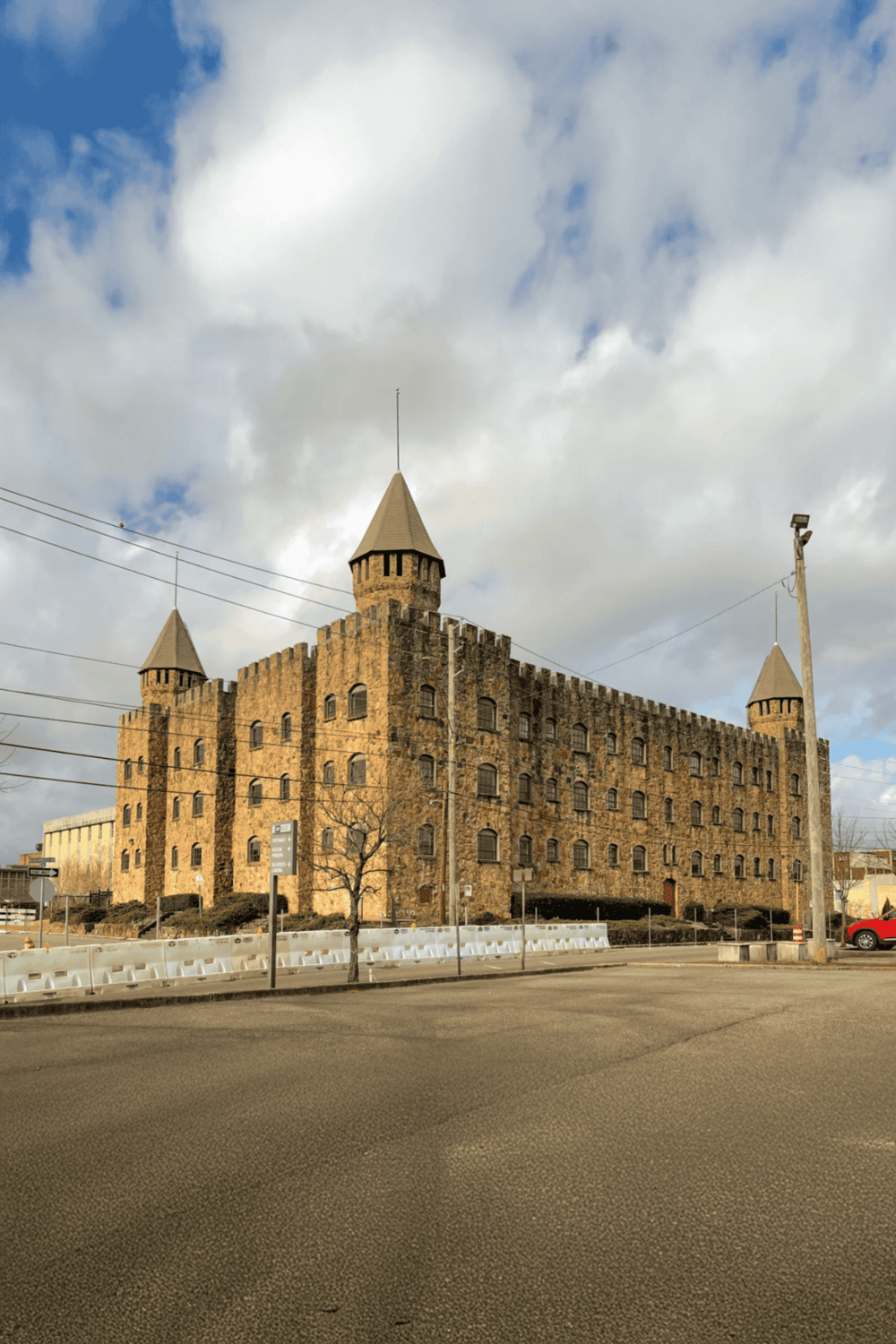 1. Historic castle building with turrets and stone walls in a city street setting.