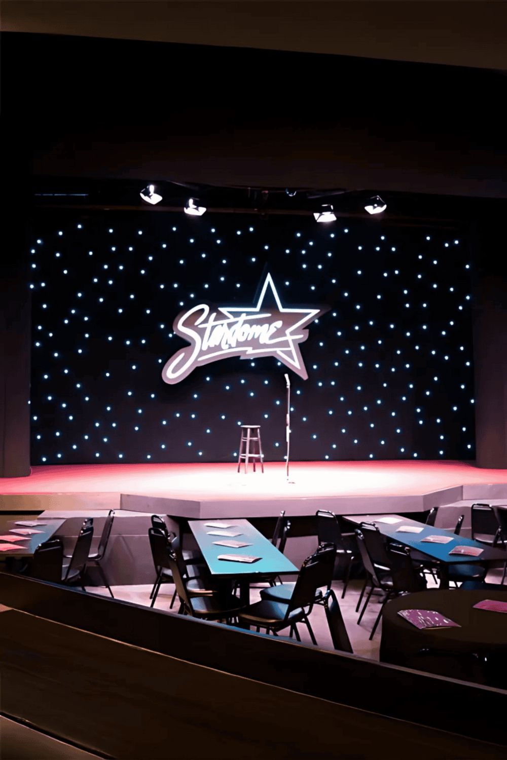 StarTone comedy club stage with seating and neon sign, live event venue in Nashville, Tennessee.