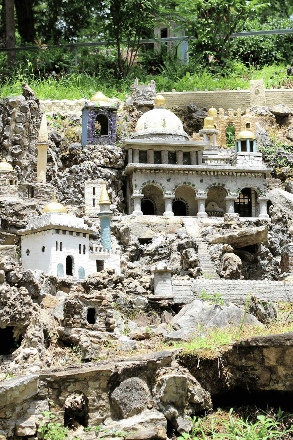 Miniature castle garden with detailed architectural replicas, perfect for inspiring children's adventure and imagination.