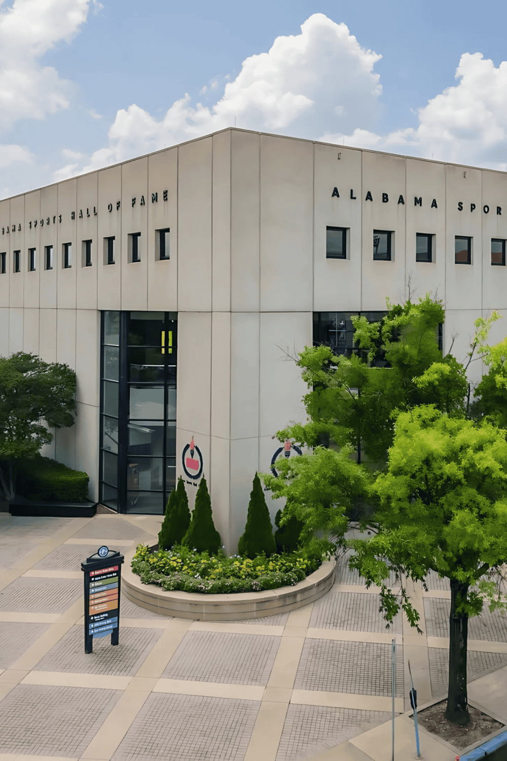 Alabama Sports Hall of Fame building exterior, modern architecture, lush greenery, Alabama tourism attraction.