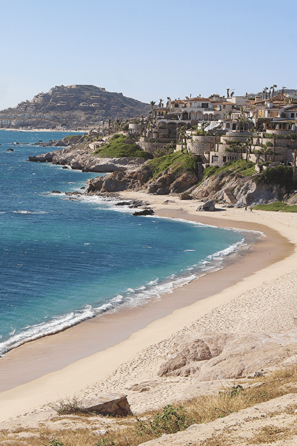 Cliffside luxury homes overlooking the ocean in a scenic coastal neighborhood.