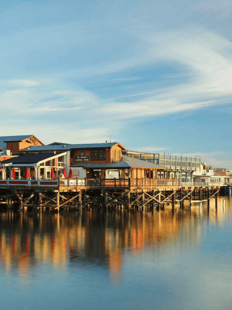 Charming waterfront restaurant and pier at sunset, scenic views, ideal for dining and leisure.