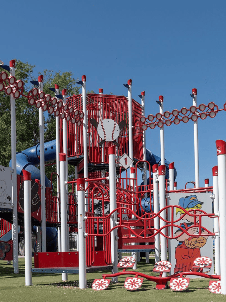 Colorful playground equipment featuring baseball theme, slides, and climbing structures for children.