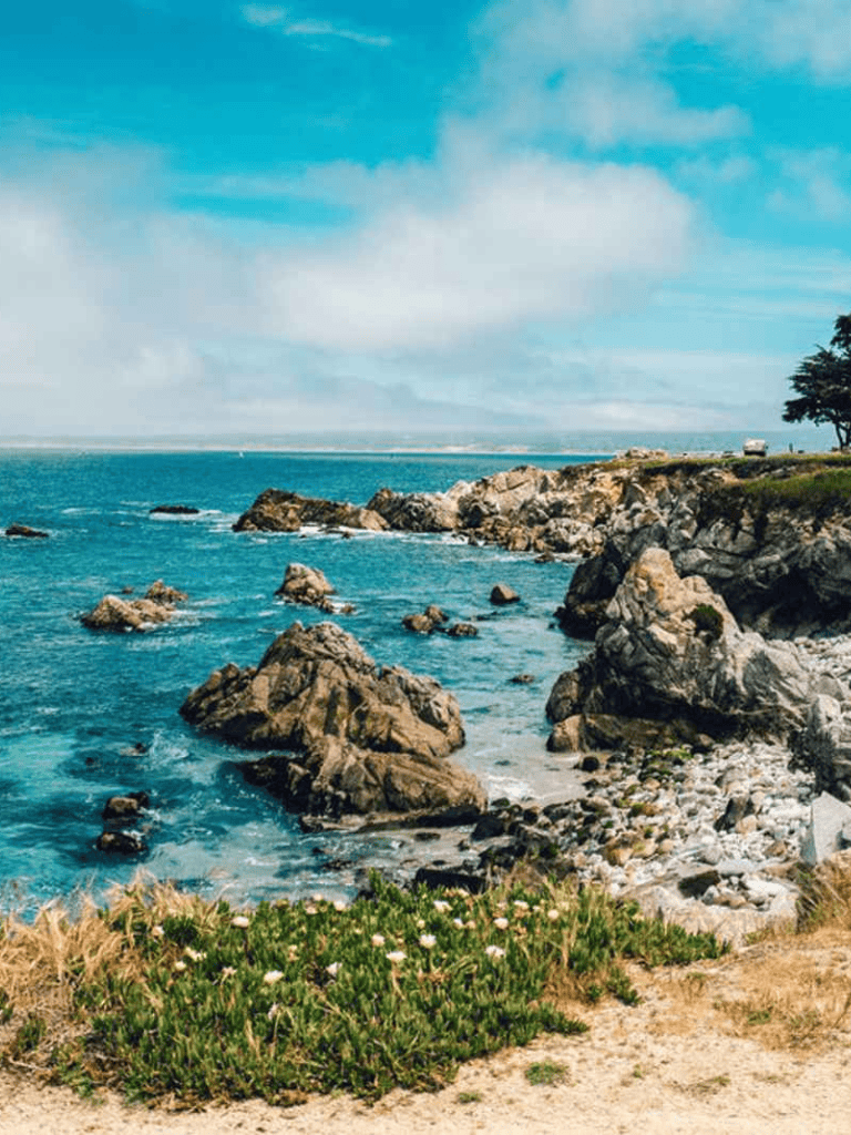 Breathtaking coastal landscape with rocks, ocean, and blue sky, perfect for travel and adventure.