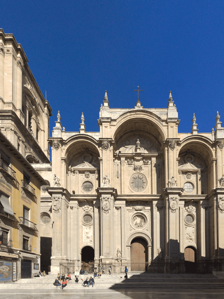 Grand Baroque Cathedral in Sicily, Italy, with detailed architecture and vibrant blue sky.