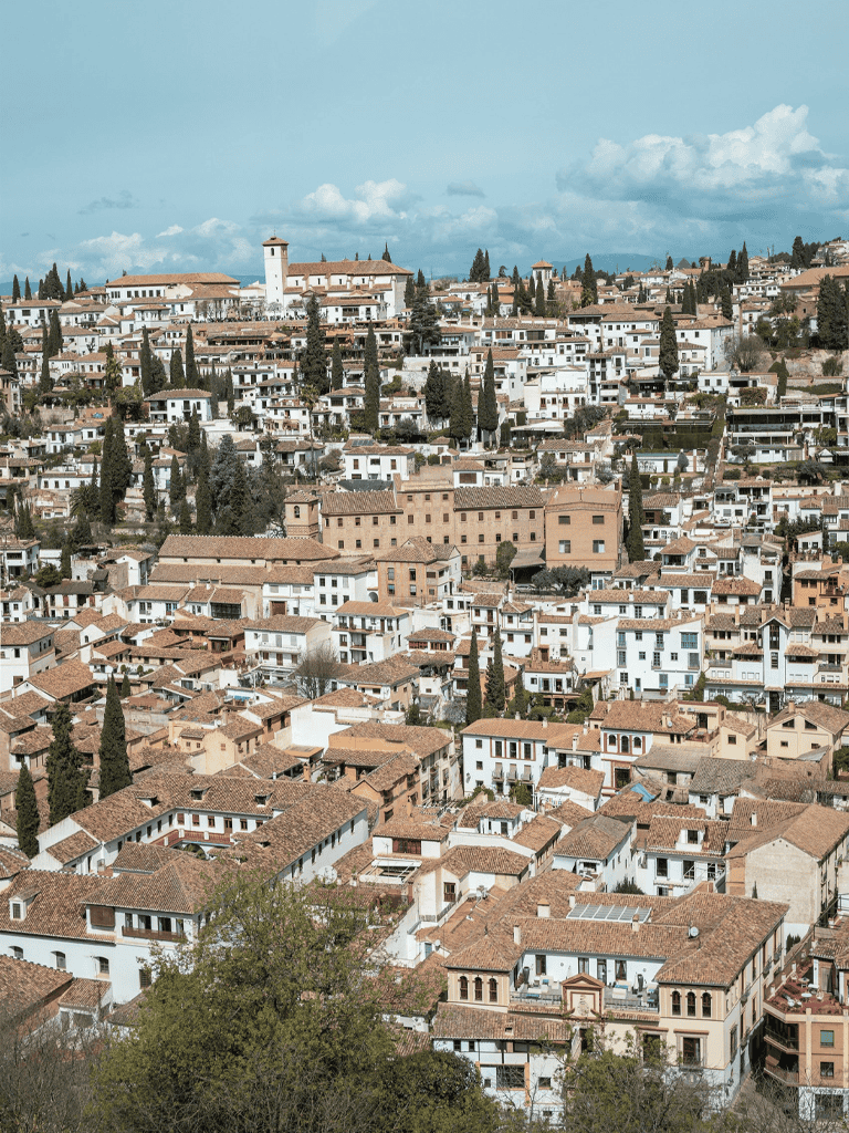 Charming hillside neighborhood with Mediterranean-style homes and lush greenery in Santa Barbara, California.