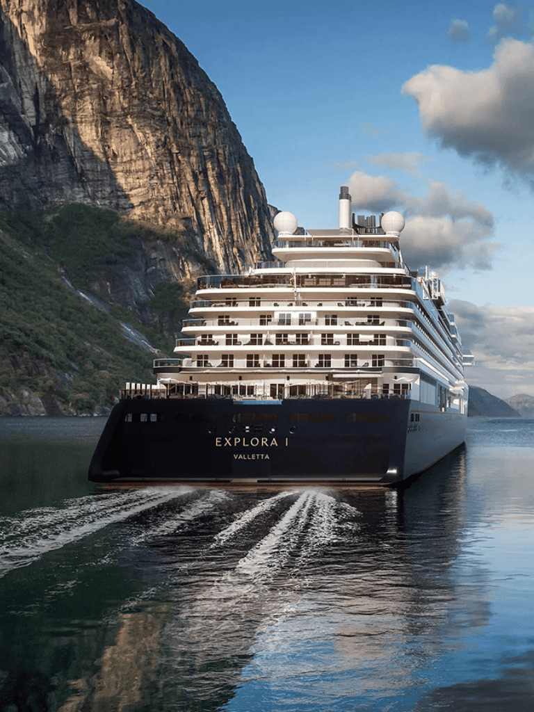 Luxurious cruise ship exploring fjord landscape for travel and tourism.