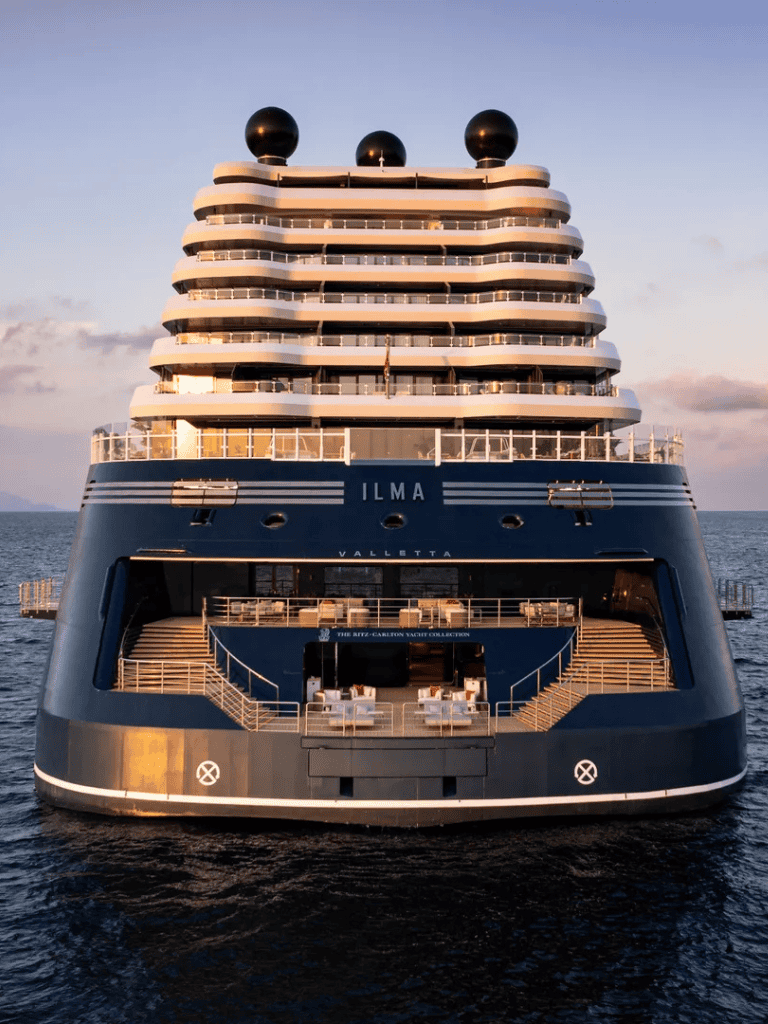 Luxurious yacht Ilma docked at sea with modern design and multiple decks, perfect for luxury travel and yacht charters.