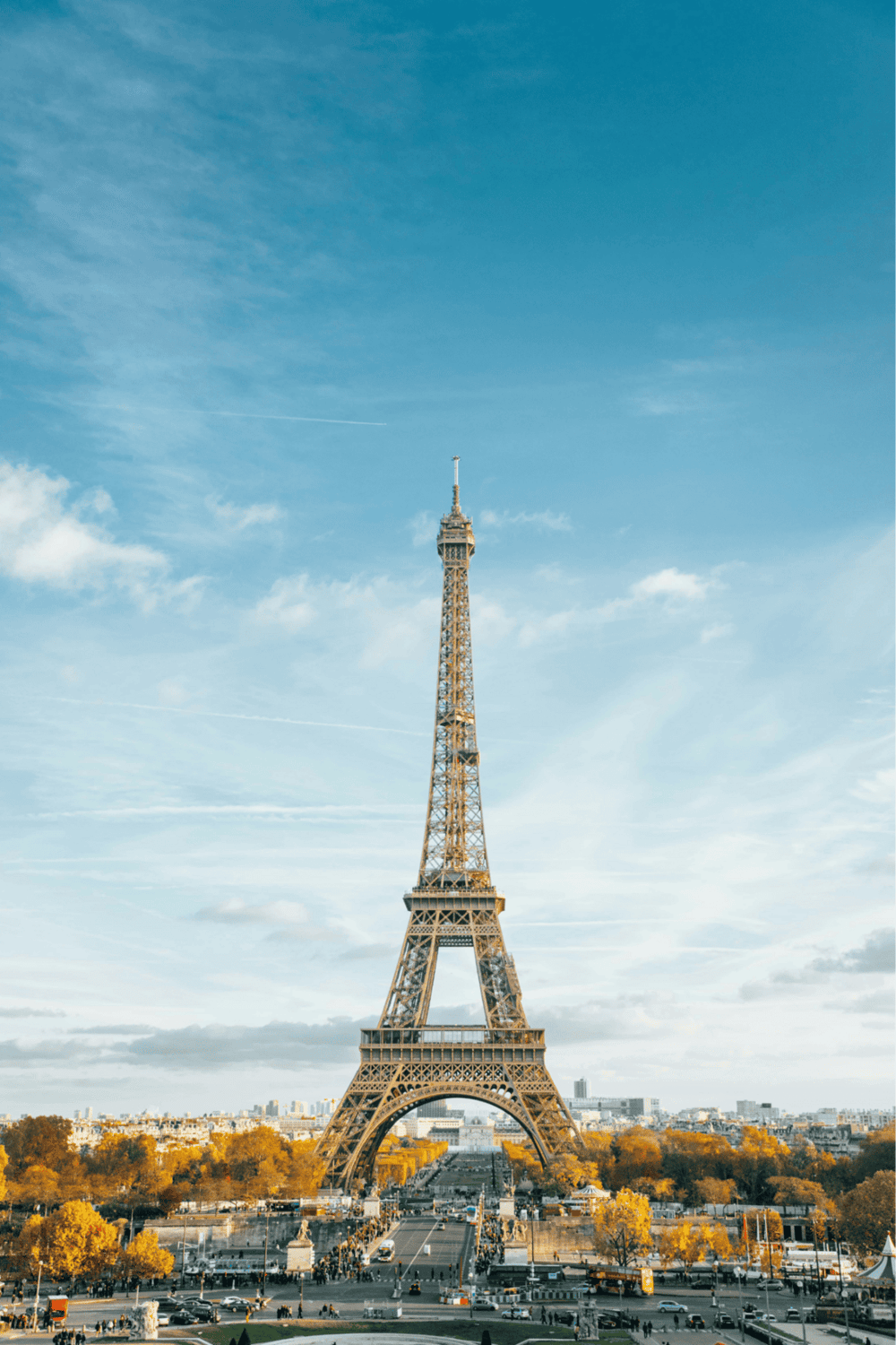 Eiffel Tower in Paris with clear blue sky and autumn trees.