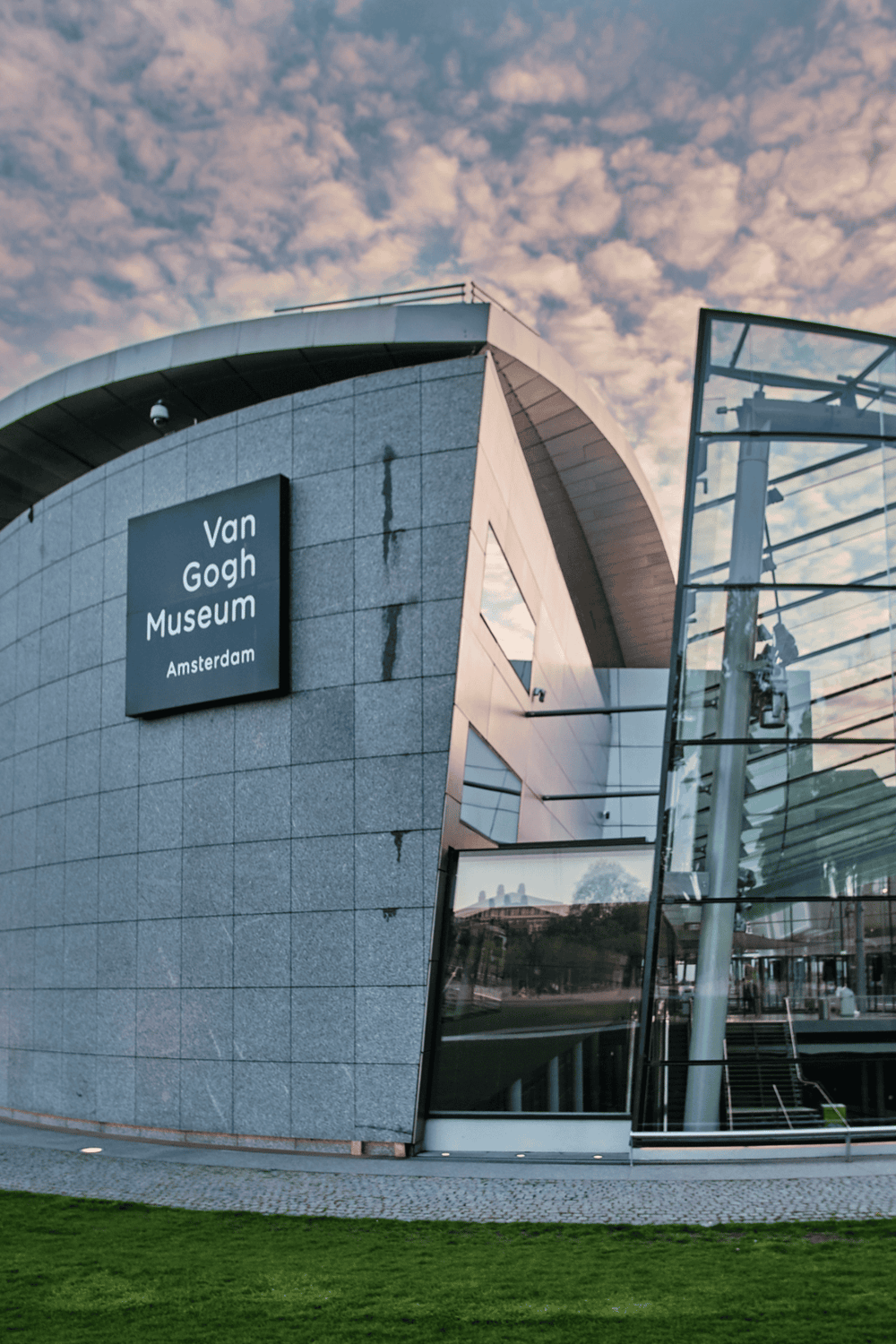 Modern Van Gogh Museum in Amsterdam with innovative architecture and glass facade.