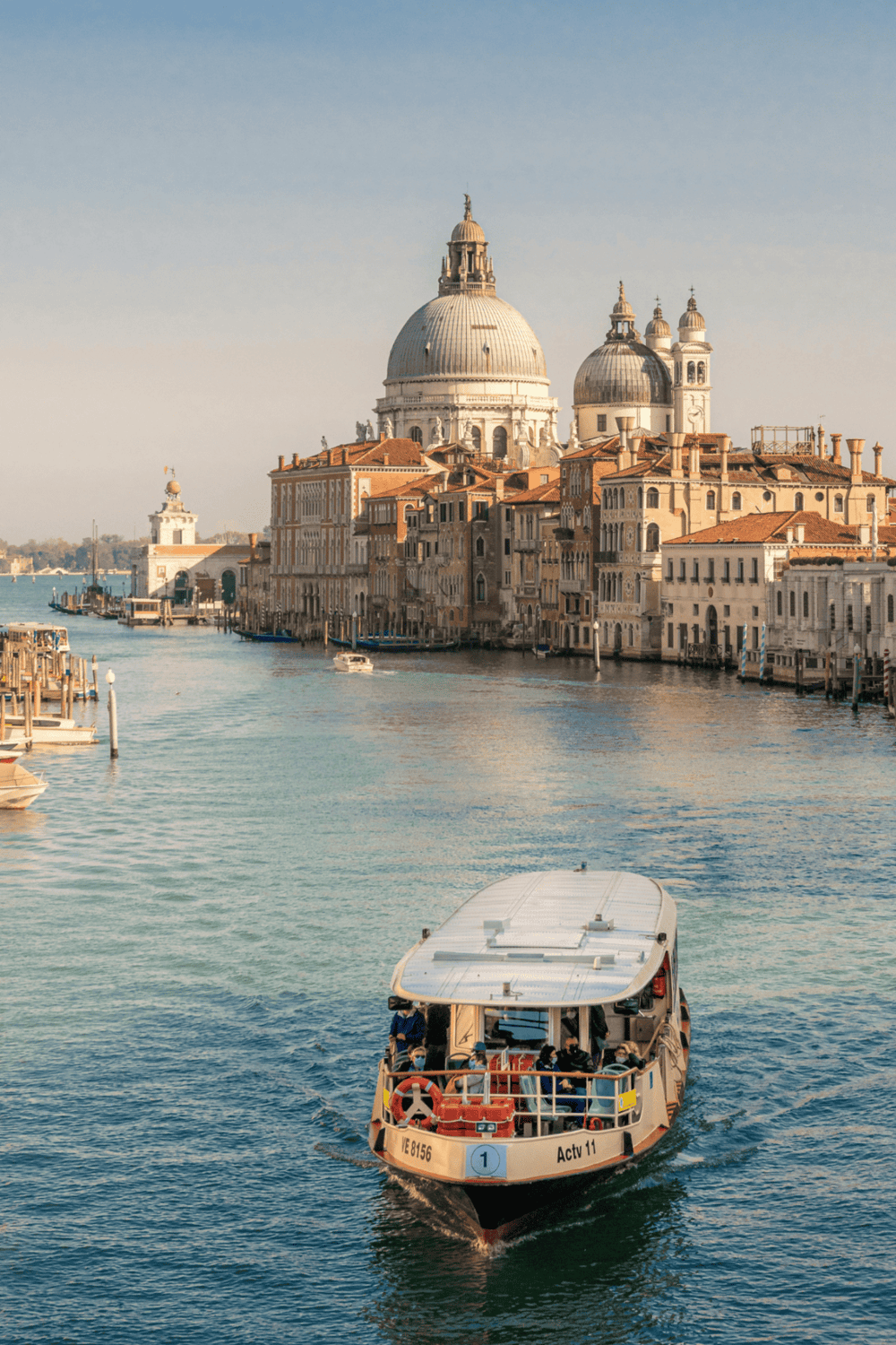 Venetian canal with historic architecture and a water taxi in Venice, Italy, showcasing beautiful cityscape and waterfront transportation.