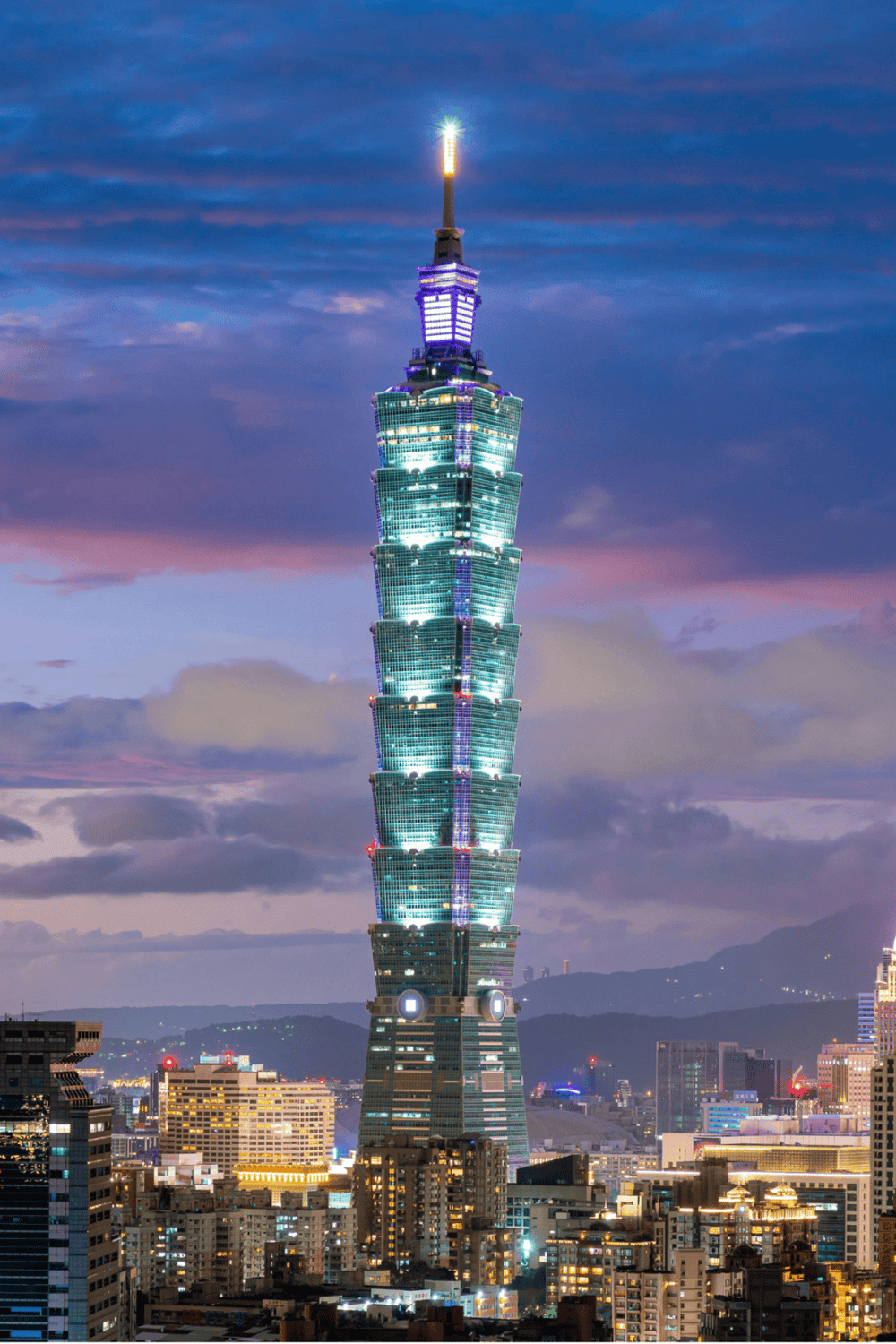 Elegant Taipei 101 skyscraper illuminated at twilight, showcasing modern architecture and city skyline.