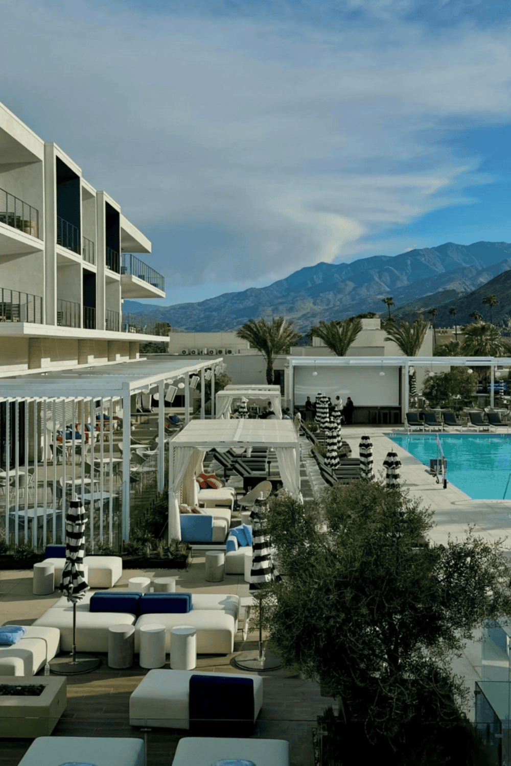 Luxurious hotel poolside lounge area with mountain views and modern amenities | QuestForDirections.