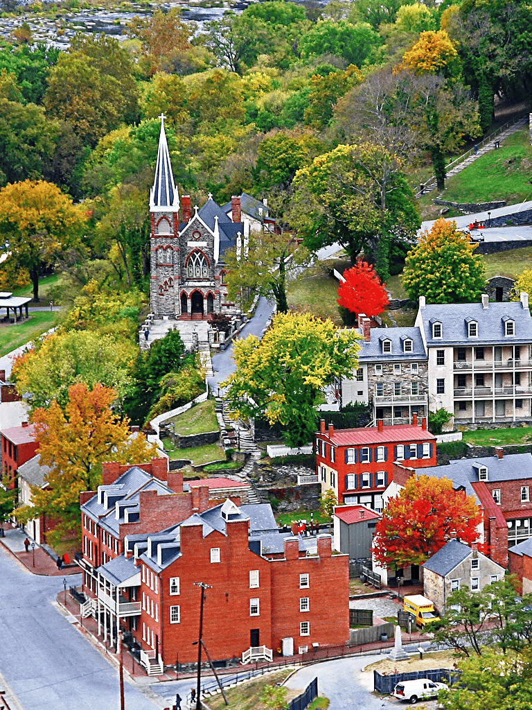 Colorful autumn church and historic homes in a quaint mountain town.