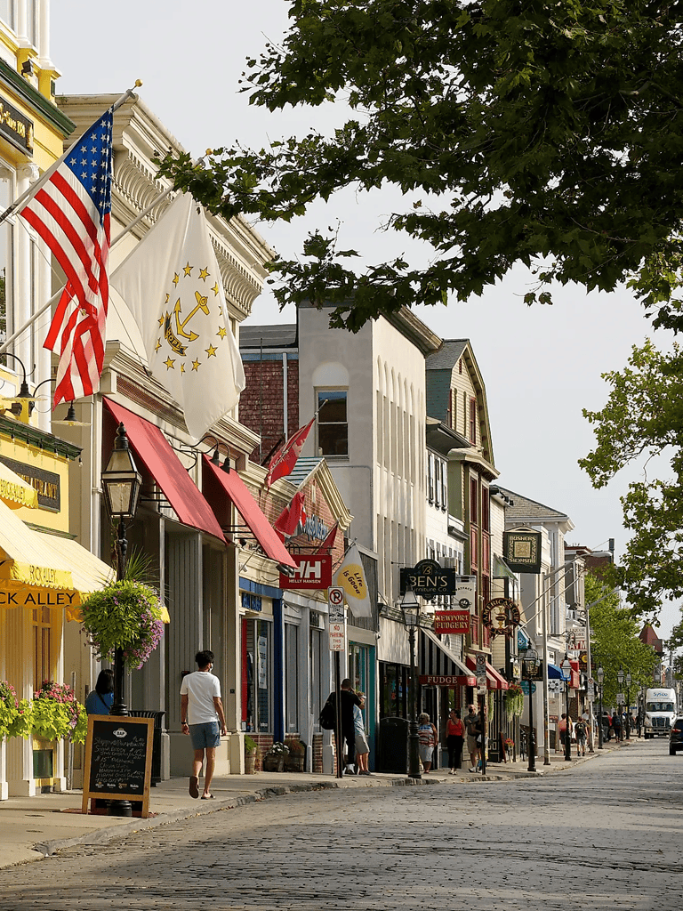 Charming Main Street with colorful shops and flags, perfect for shopping and exploring local businesses.