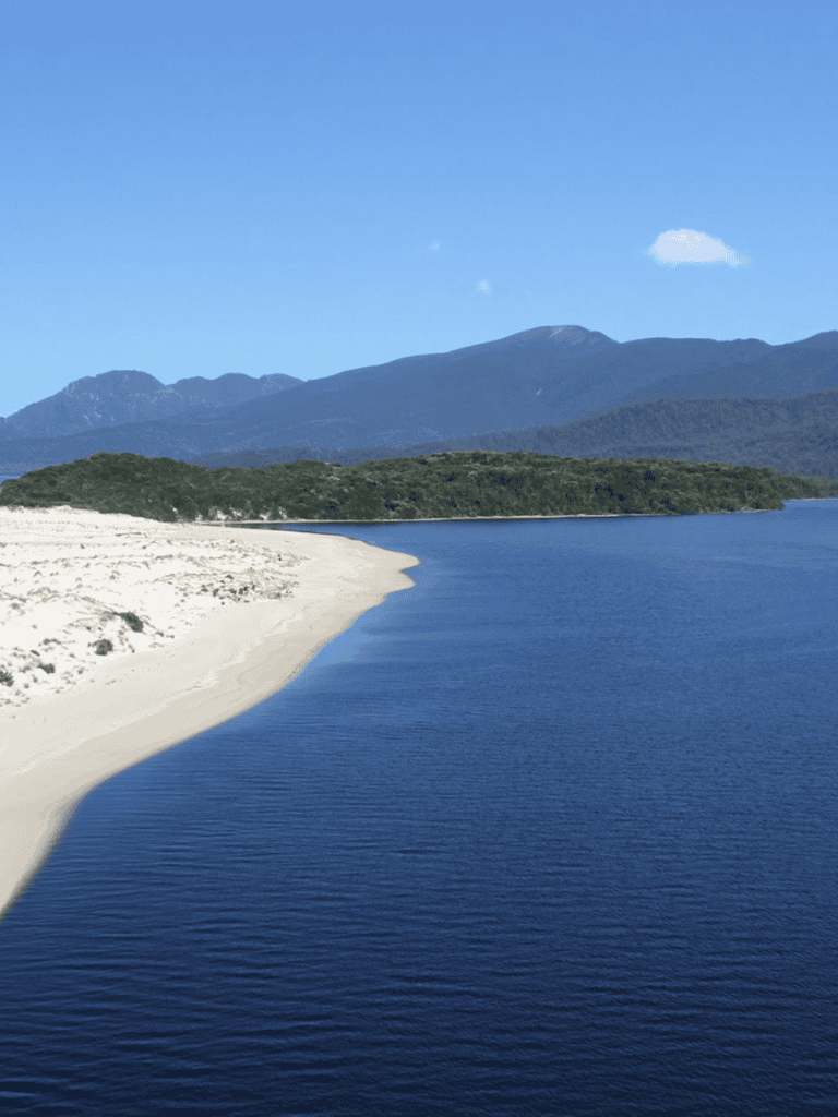 Scenic coastal landscape with mountains, beach, and water view, ideal for travel and outdoor adventure.