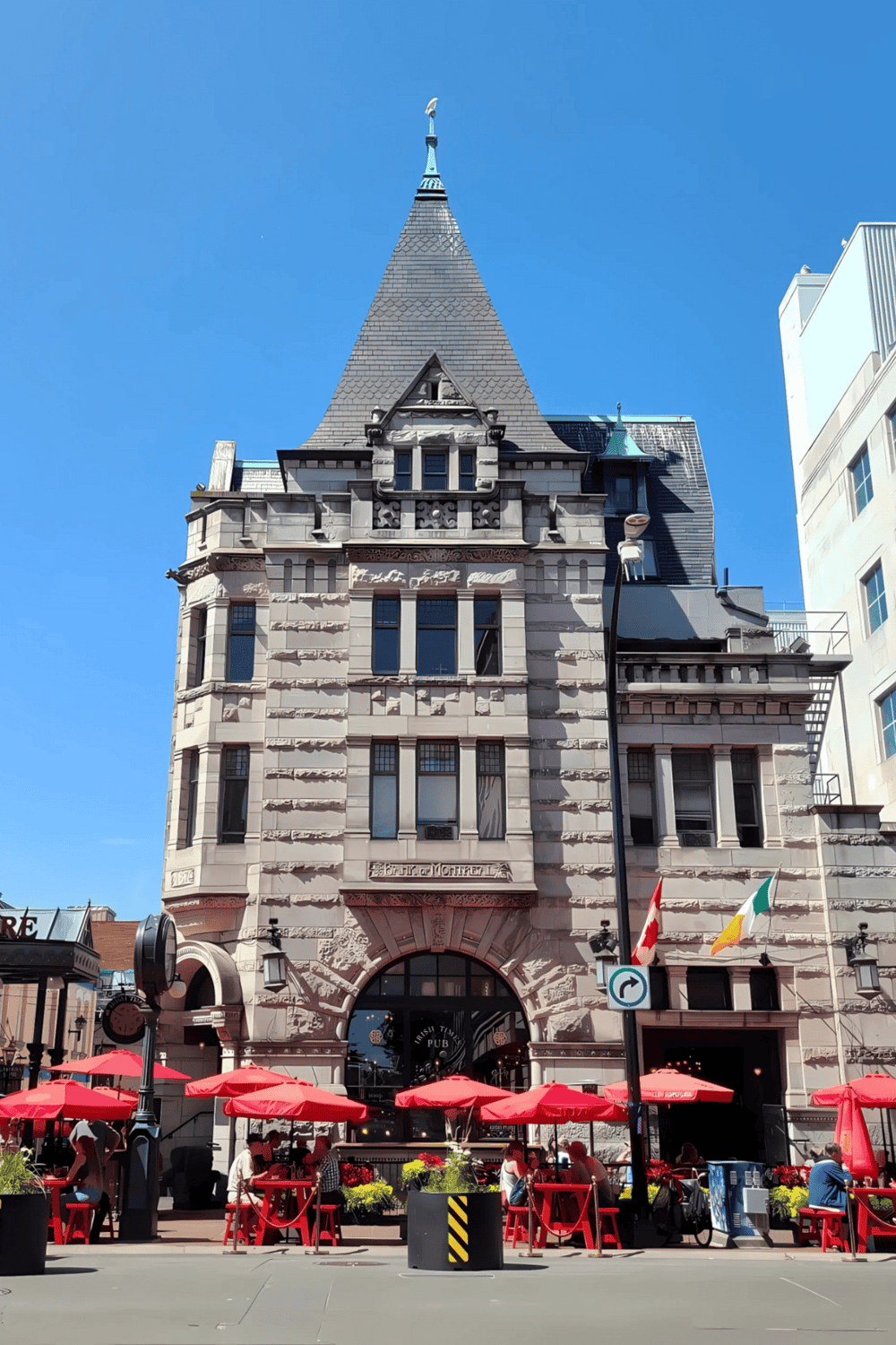 Historic building with Tudor architecture in downtown, featuring outdoor seating and vibrant city atmosphere.