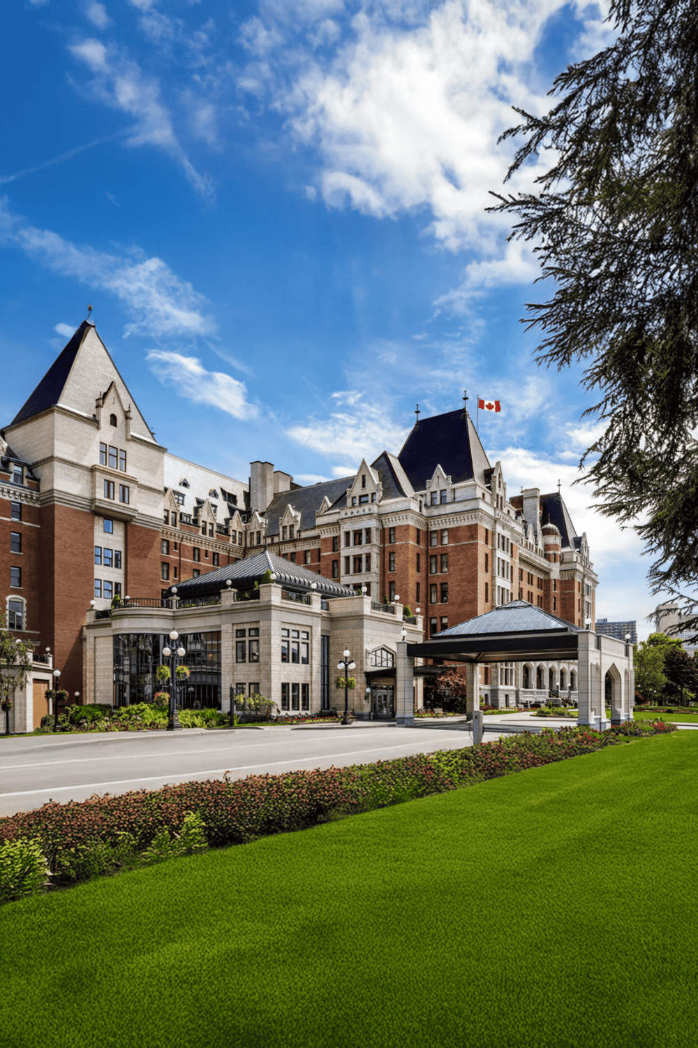 Luxury castle hotel with turrets and landscaped gardens, located in Canada.