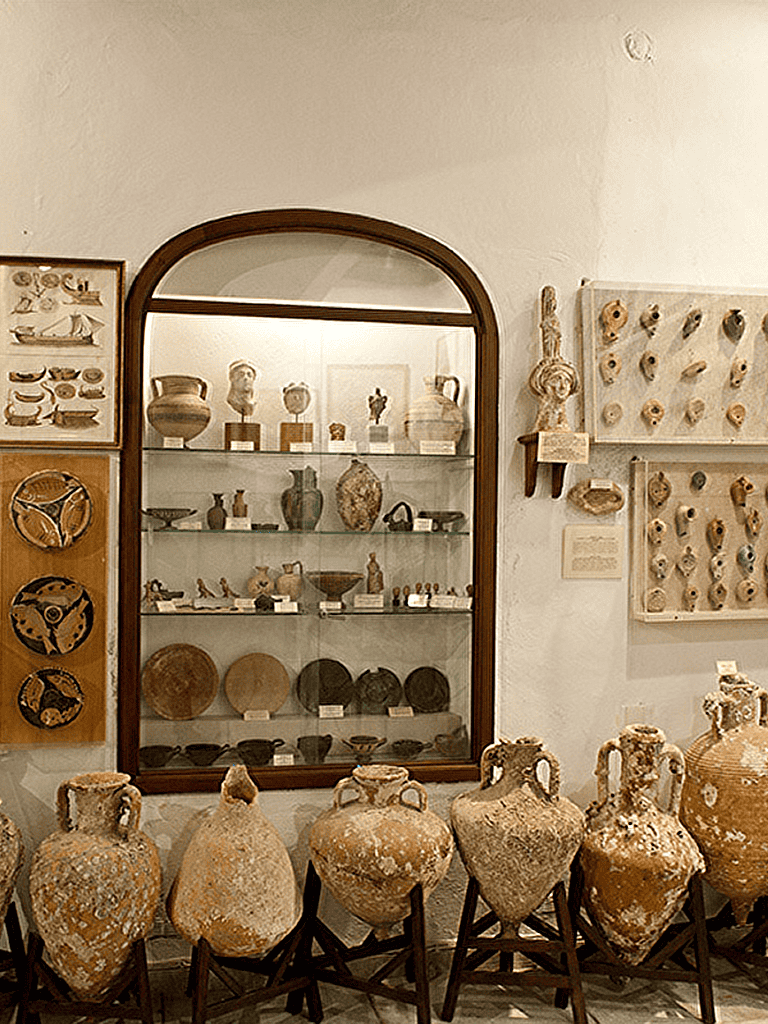 Ancient pottery display at Quest For Directions museum, showcasing historical artifacts and sculptures.