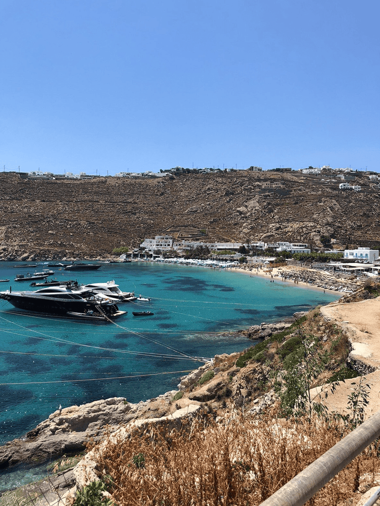 Breathtaking harbor with yachts on clear blue waters in a scenic coastal town.