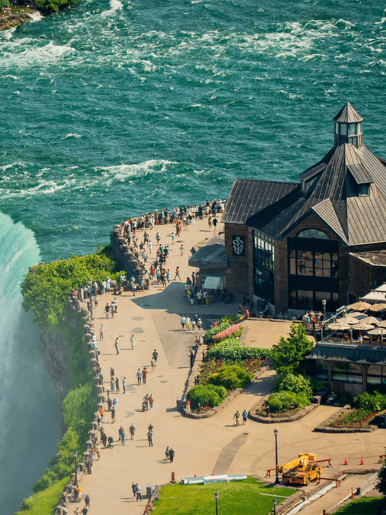 Crowd at Niagara Falls Observation Area, Canada. Famous natural wonder attracts visitors globally.