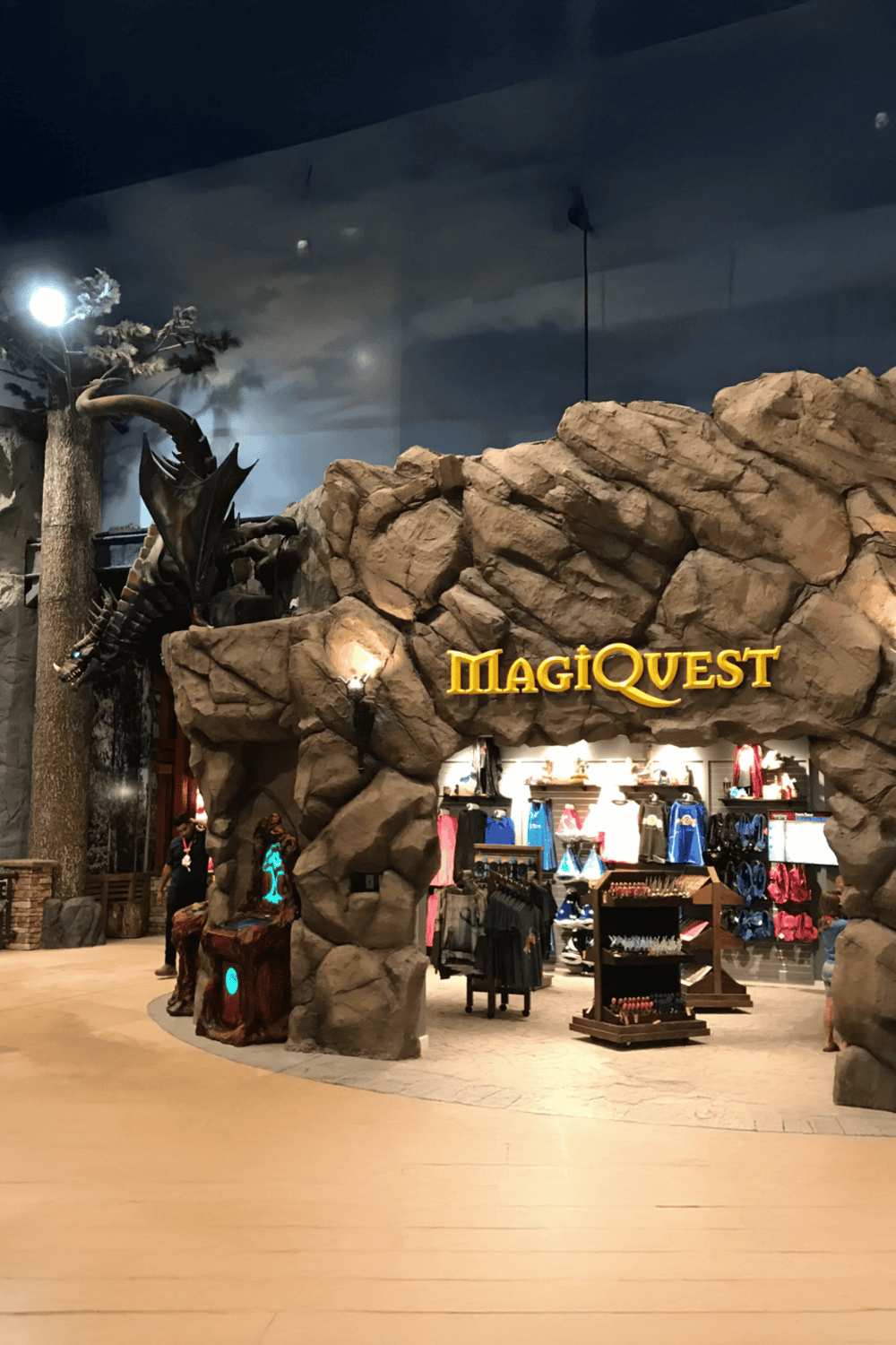 1. Adventure-themed retail store with rock and dragon display for MagicQuest.