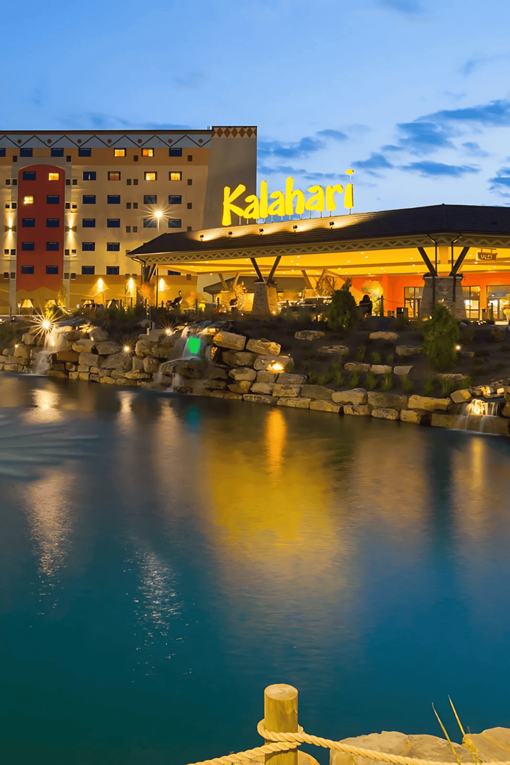 Expensive hotel Kalahari resort with water park and fountain, illuminated at night for guests.
