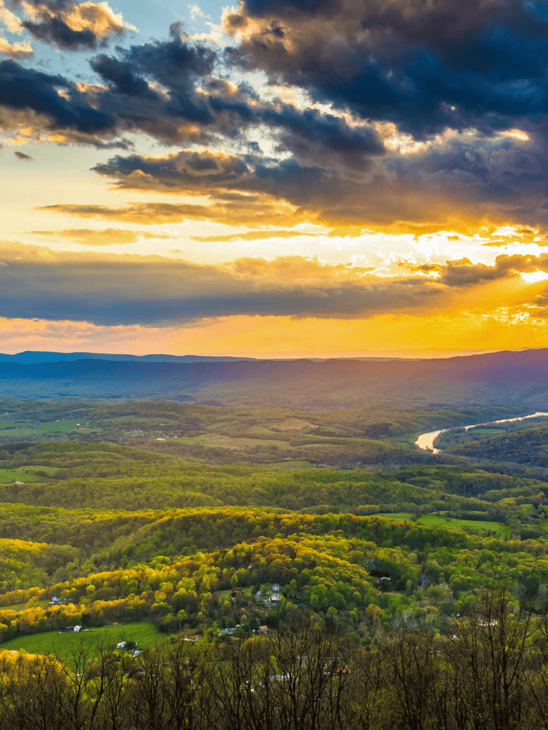 Breathtaking landscape with lush green hills and river at sunset for scenic navigation.