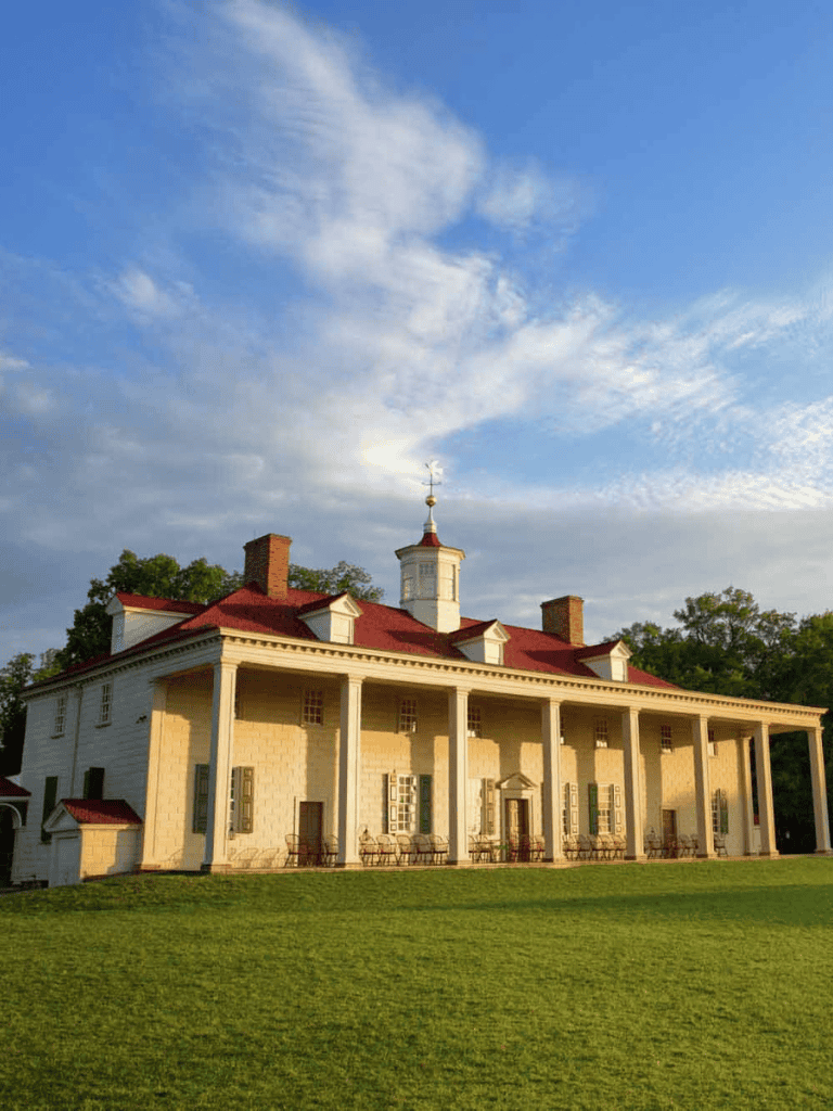 Elegant historic estate with colonial architecture and lush green surroundings.