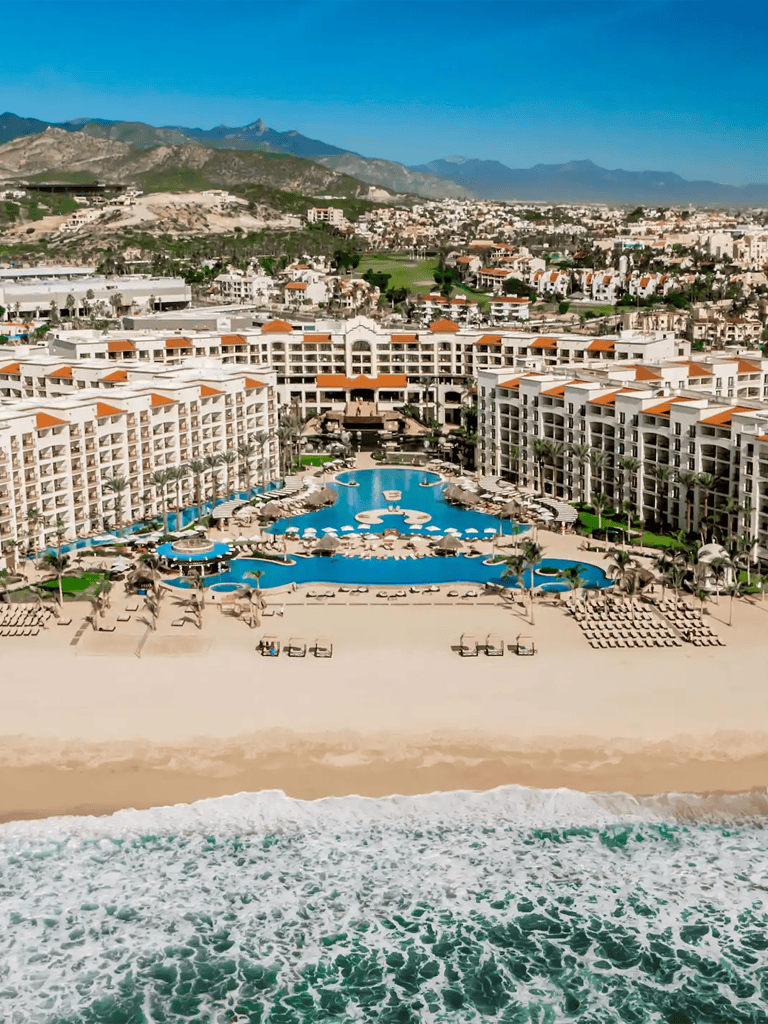 Luxurious beachfront resort with pools and ocean view in Los Cabos, Mexico.