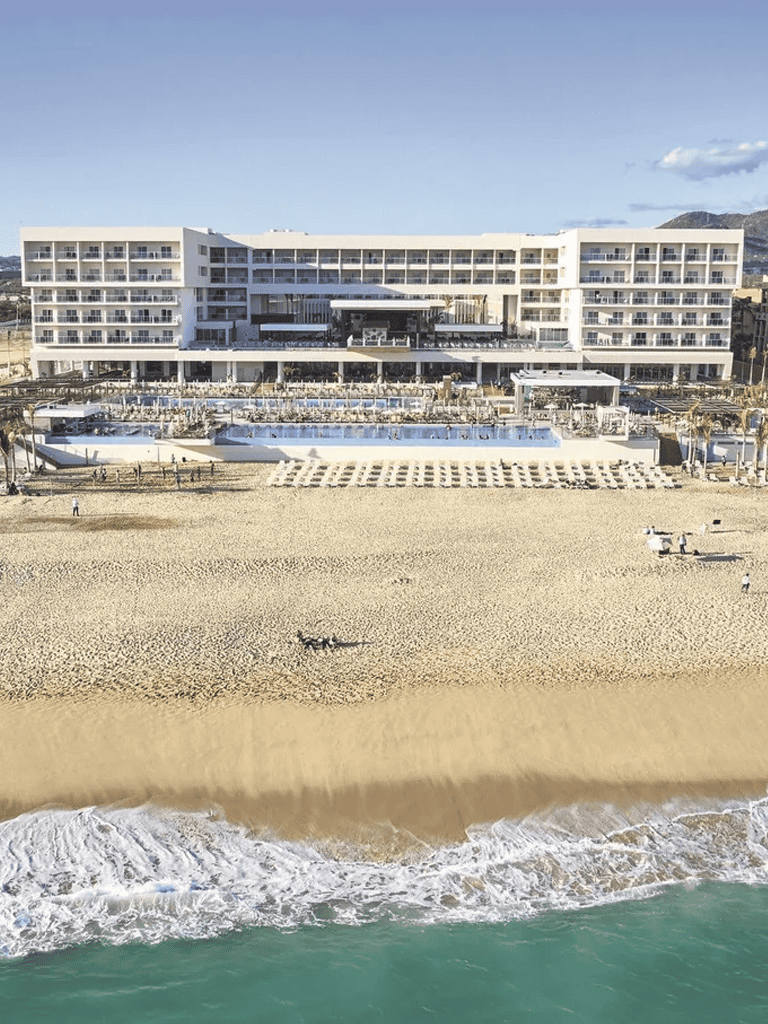 Modern beachfront hotel with pools and ocean view, perfect for luxury vacation stays.